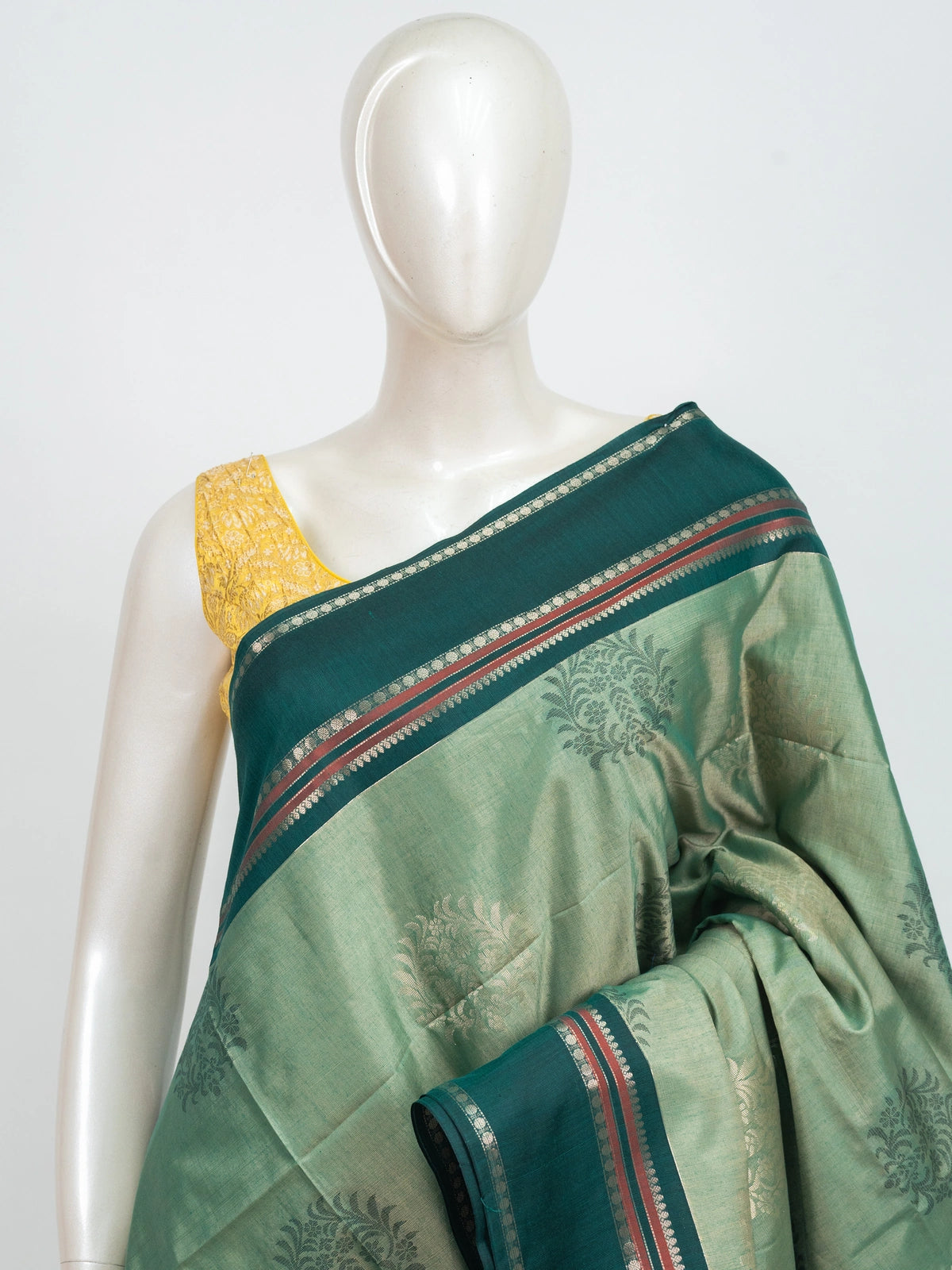 Sage green Kanchipuram fancy silk saree with contrast teal silver zari border and floral butta body