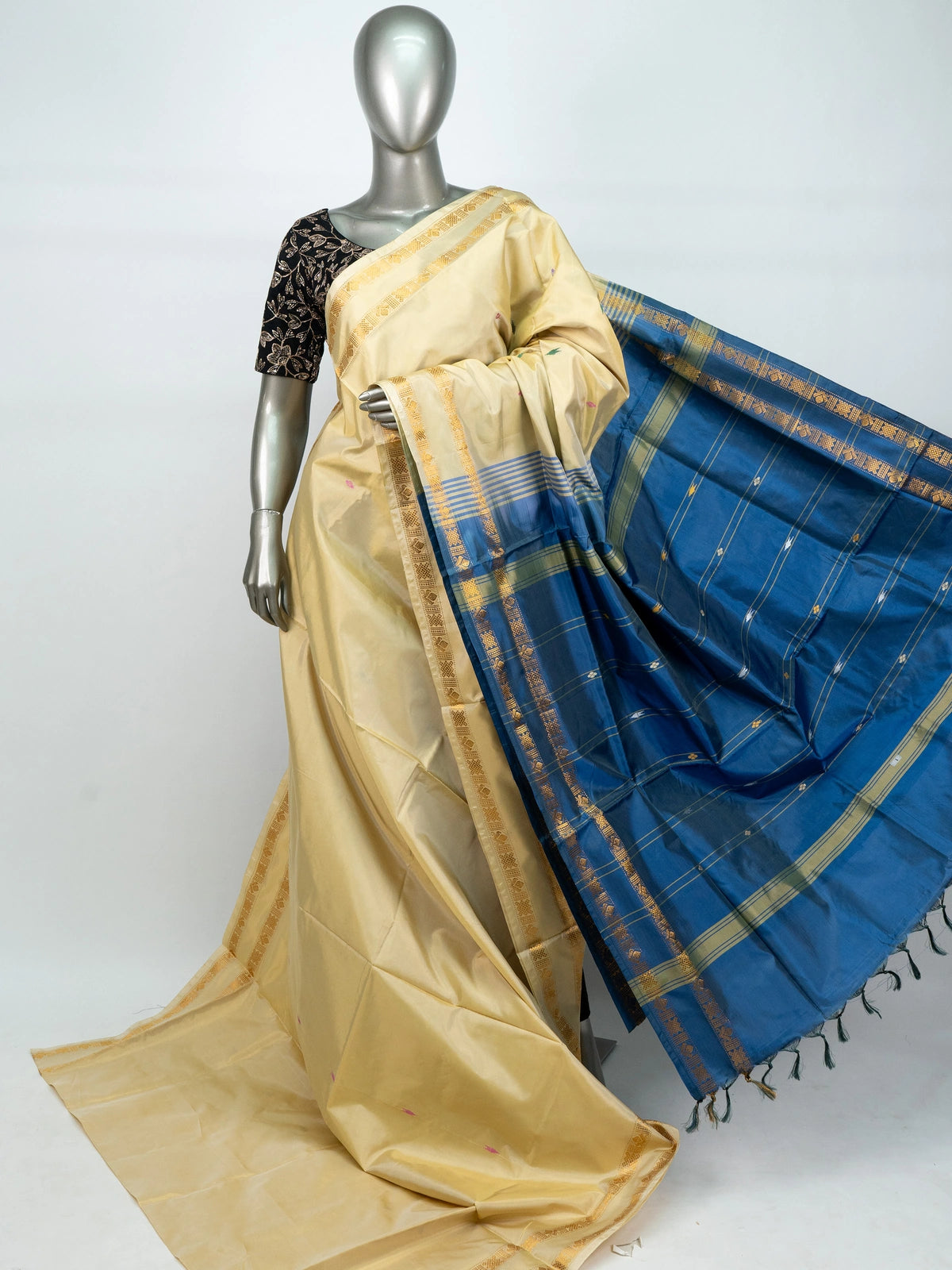 Cream and blue banana silk saree with gold zari border and contrast blue pallu