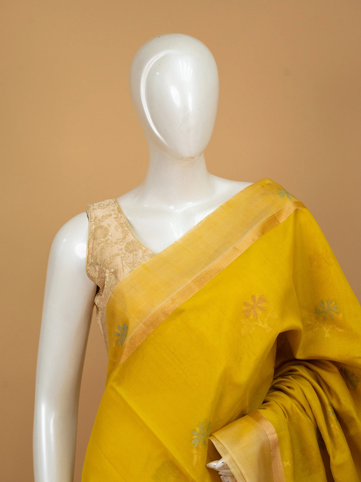 Bright yellow pure silk cotton saree with floral buta motifs and gold zari border