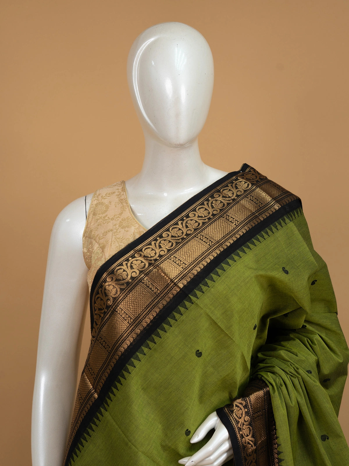 Olive green Chettinad cotton saree with black and gold zari contrast border and paisley buttas