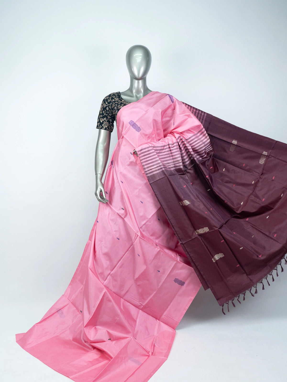 Pink banana silk saree with contrast maroon pallu, woven buti motifs, and black floral blouse