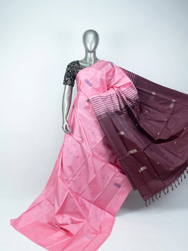 Pink banana silk saree with contrast maroon pallu, woven buti motifs, and black floral blouse