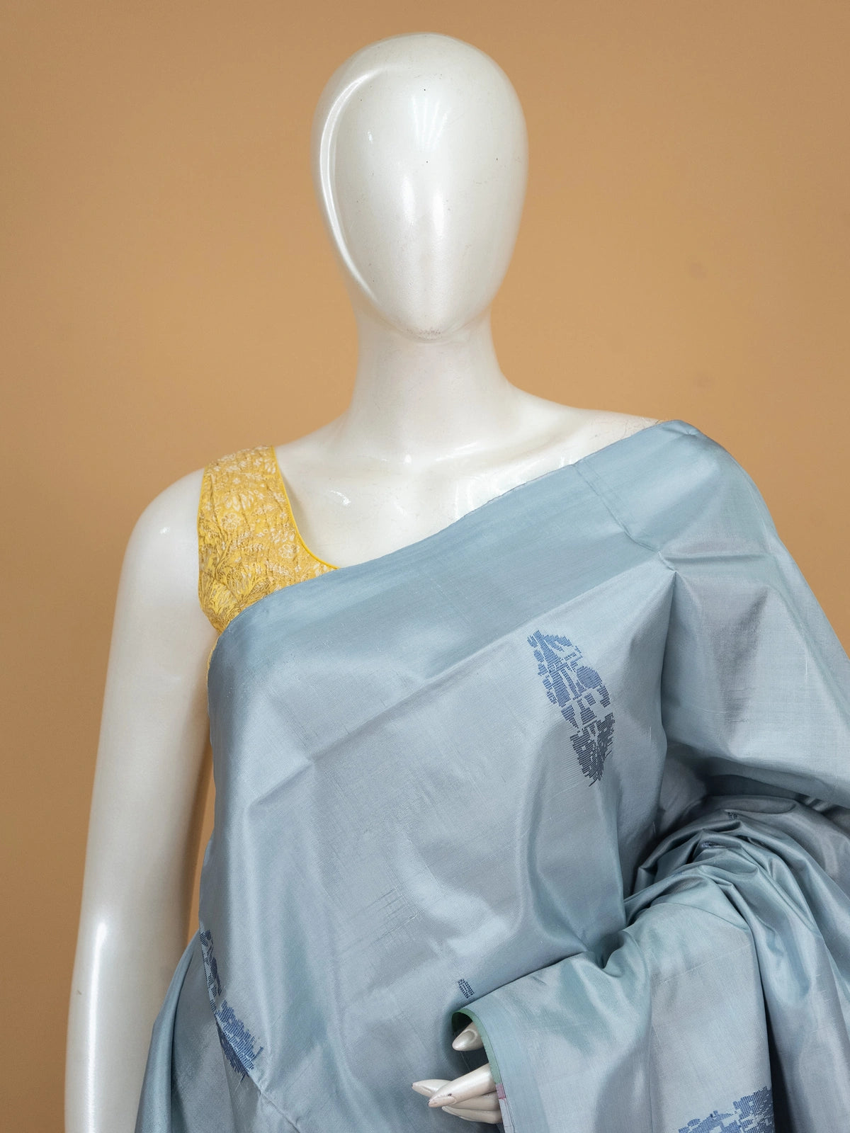 Grey-blue Banana Silk saree with blue buta motifs and a contrast red pallu with gold zari stripes
