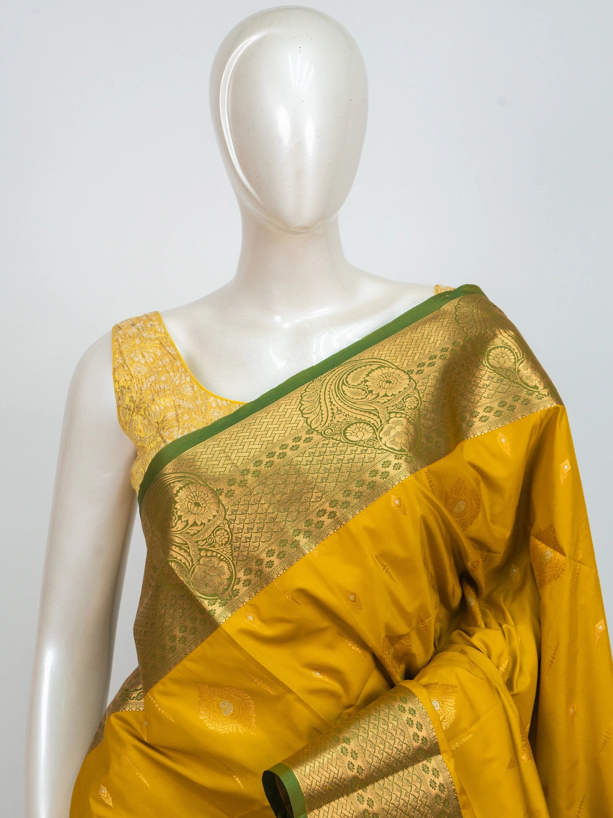 Mustard yellow Kanchipuram fancy silk saree with green contrast zari border and pallu