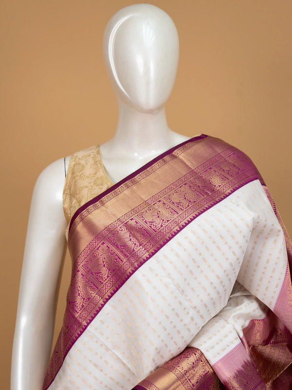 Cream pure Kanchipuram silk saree with gold zari buttis and contrast magenta zari border