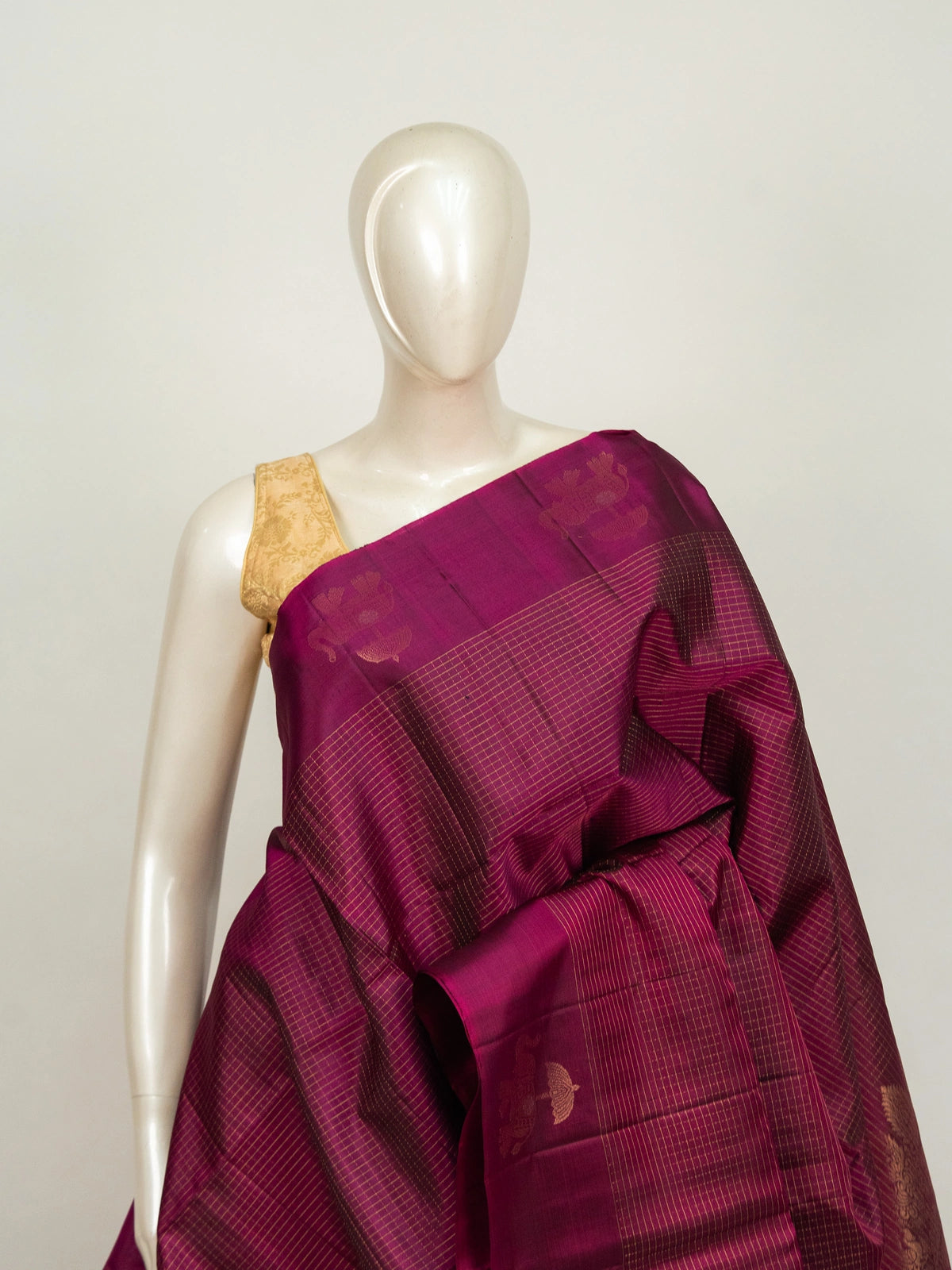 Magenta pure soft silk saree with gold zari checks, elephant motifs and ornate zari pallu