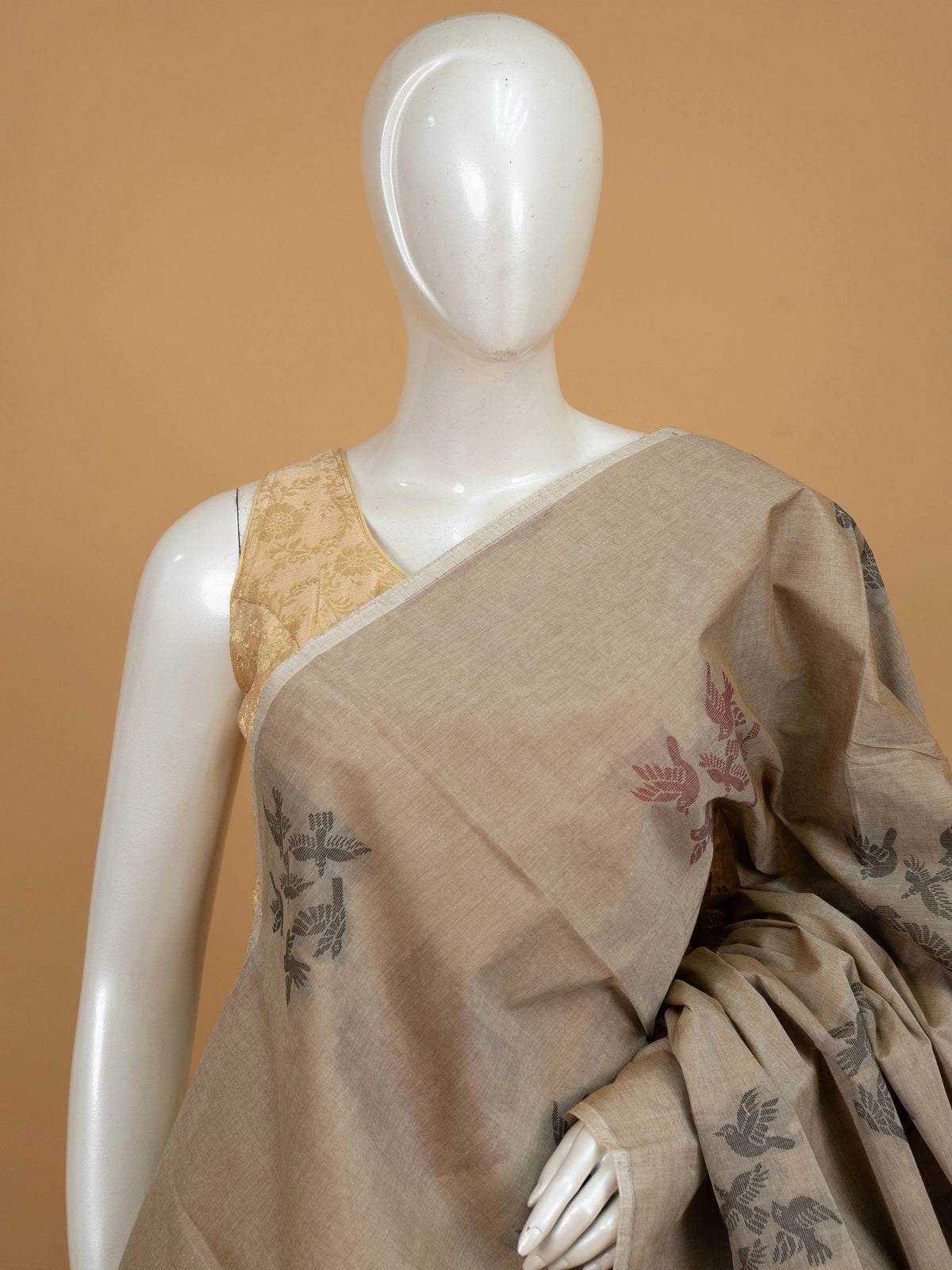 Beige silk cotton saree with grey and maroon flying-bird motifs and a bird-patterned pallu
