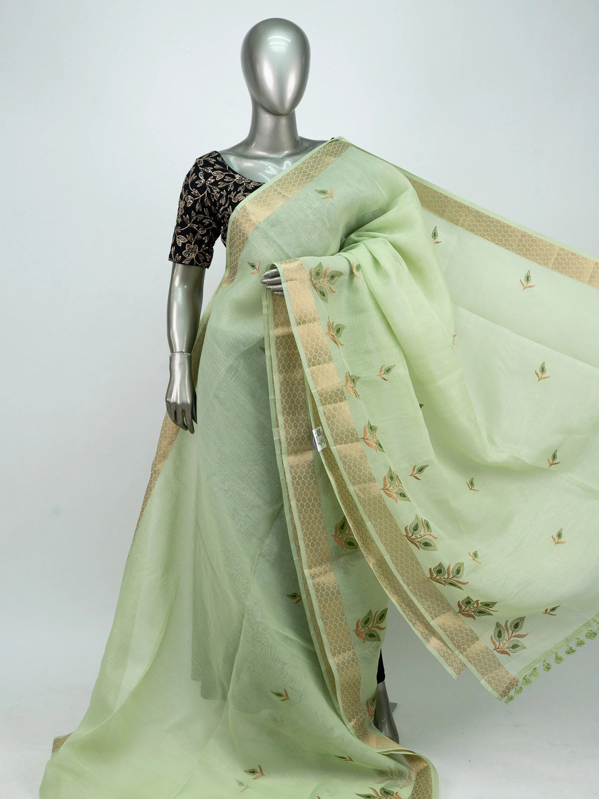 Pista green linen cotton saree with gold zari border, embroidered leaf buttas and contrast black embroidered blouse