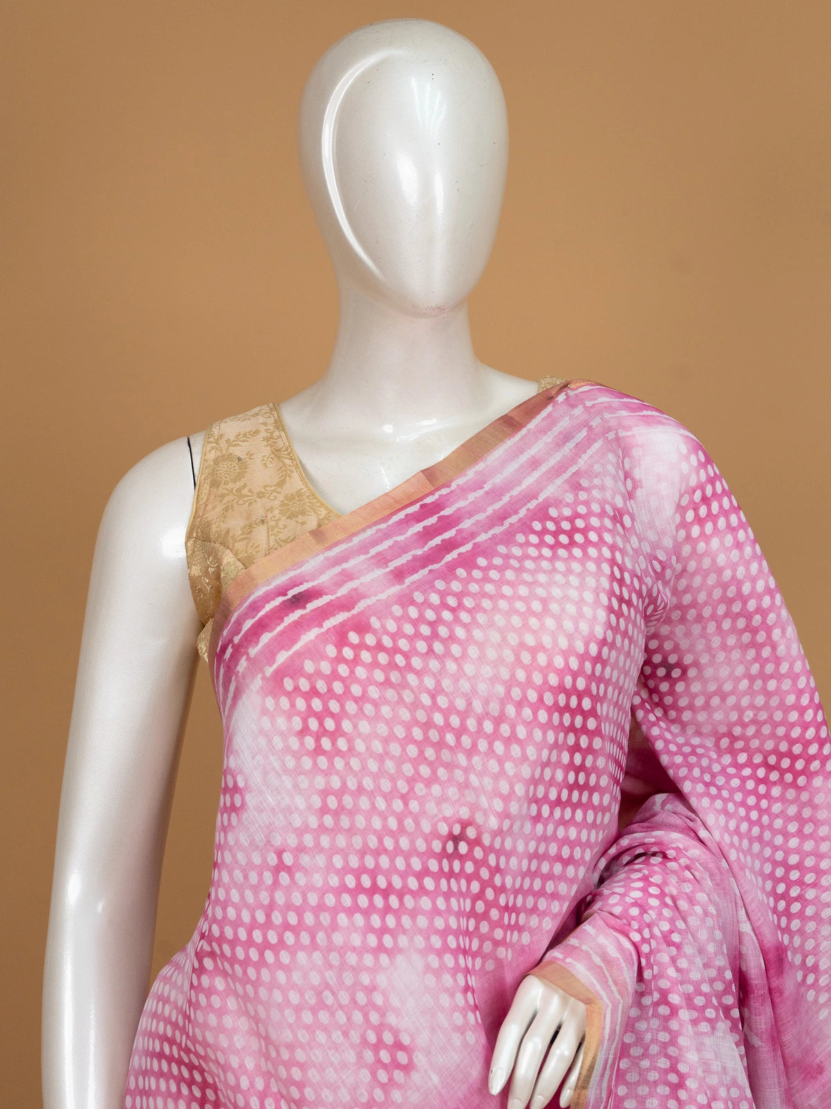 Pink and white linen cotton saree with shibori dot pattern, floral pallu and gold zari border