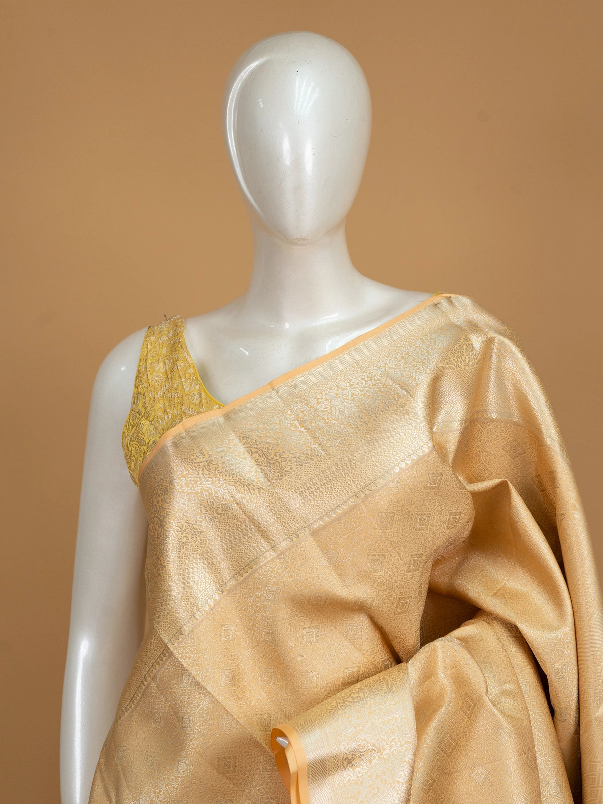 Gold and beige pure Kanchipuram silk saree with all-over gold zari weave and broad floral border
