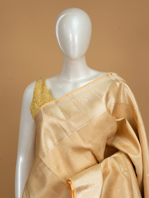 Gold and beige pure Kanchipuram silk saree with all-over gold zari weave and broad floral border