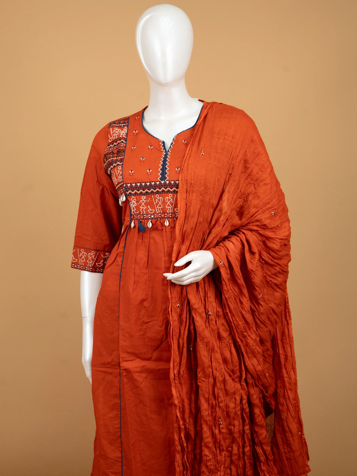 Rust orange cotton Warli embroidered Anarkali kurti set with cowrie shell tassels and matching dupatta