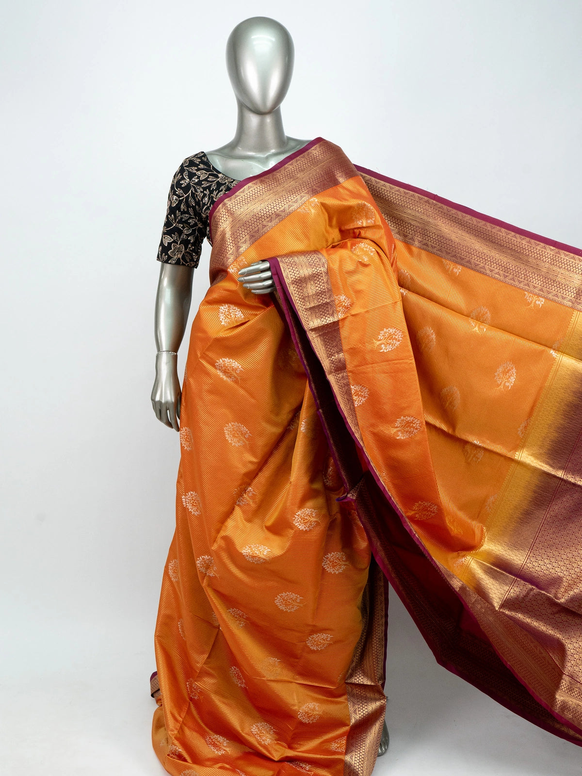 Orange soft silk saree with contrast magenta and gold zari border, woven butta motifs, and black embroidered blouse