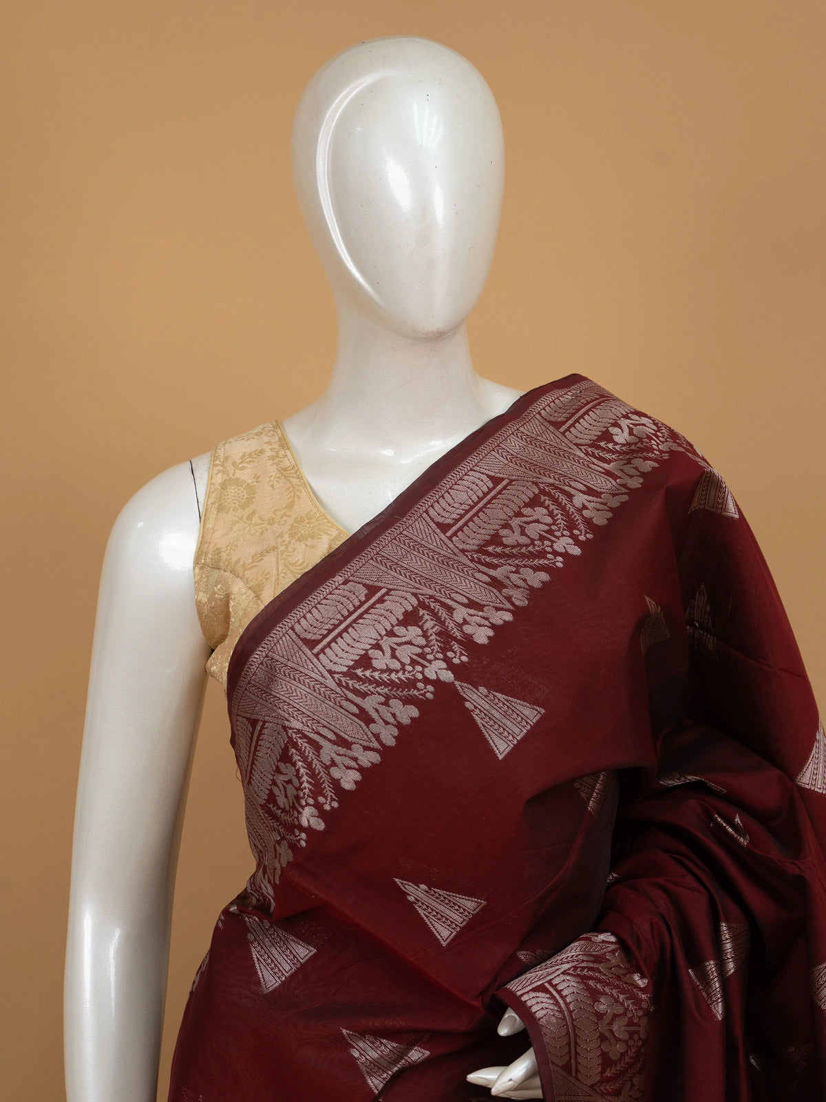 Maroon silk cotton saree with silver zari triangular motifs and contrast navy blue zari border and pallu
