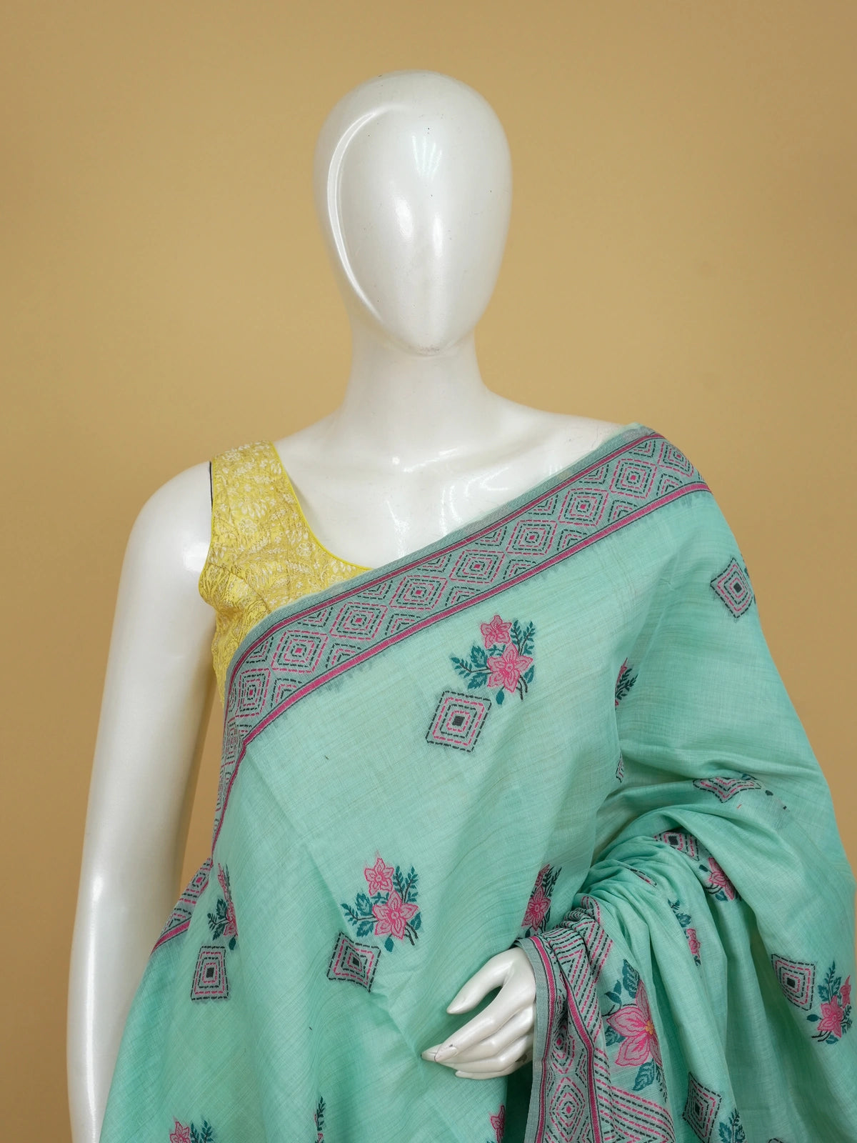 Mint green linen cotton saree with pink floral prints and geometric diamond border