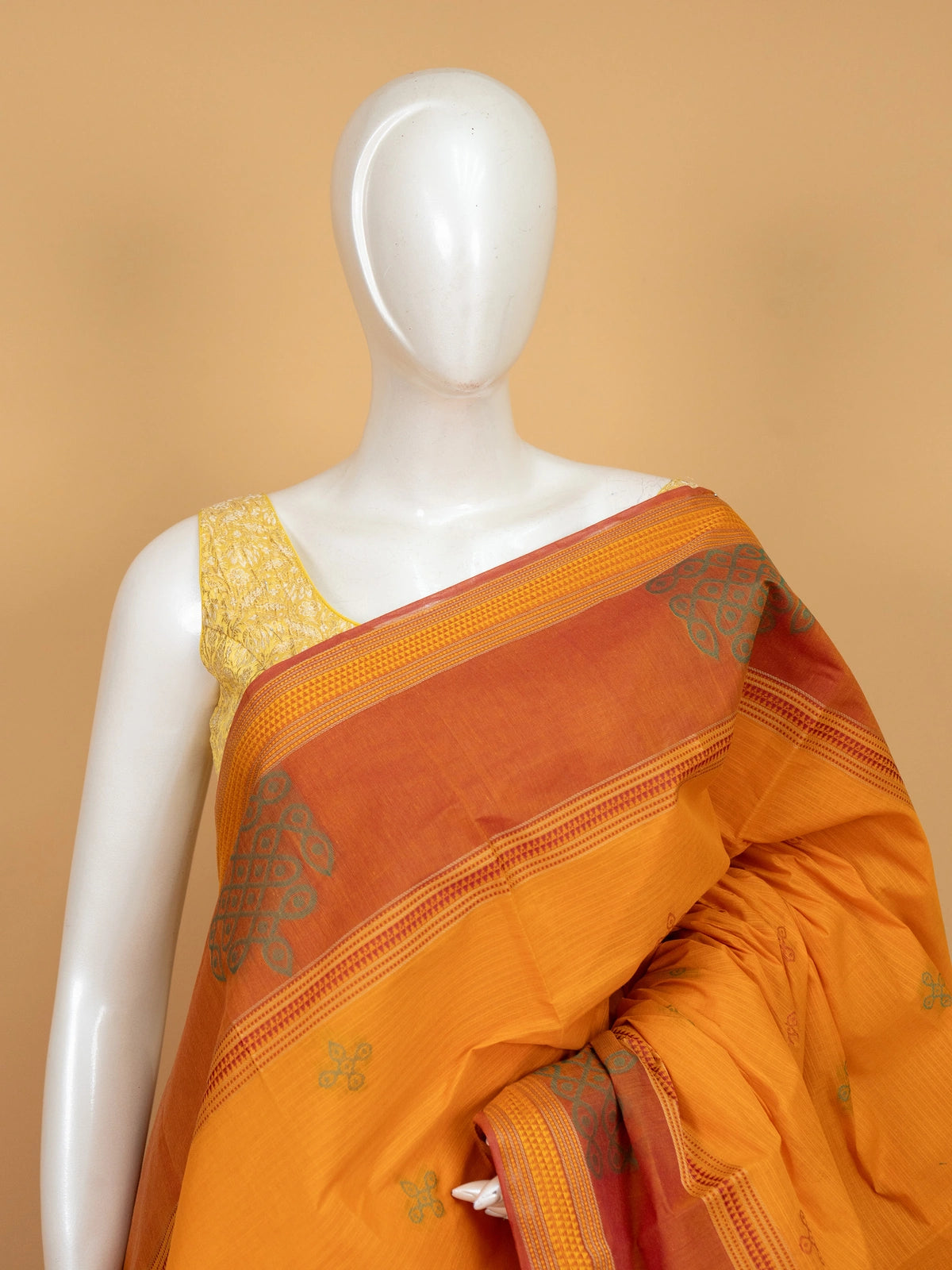 Mustard semi raw silk saree with contrast rust border and kolam-motif pallu