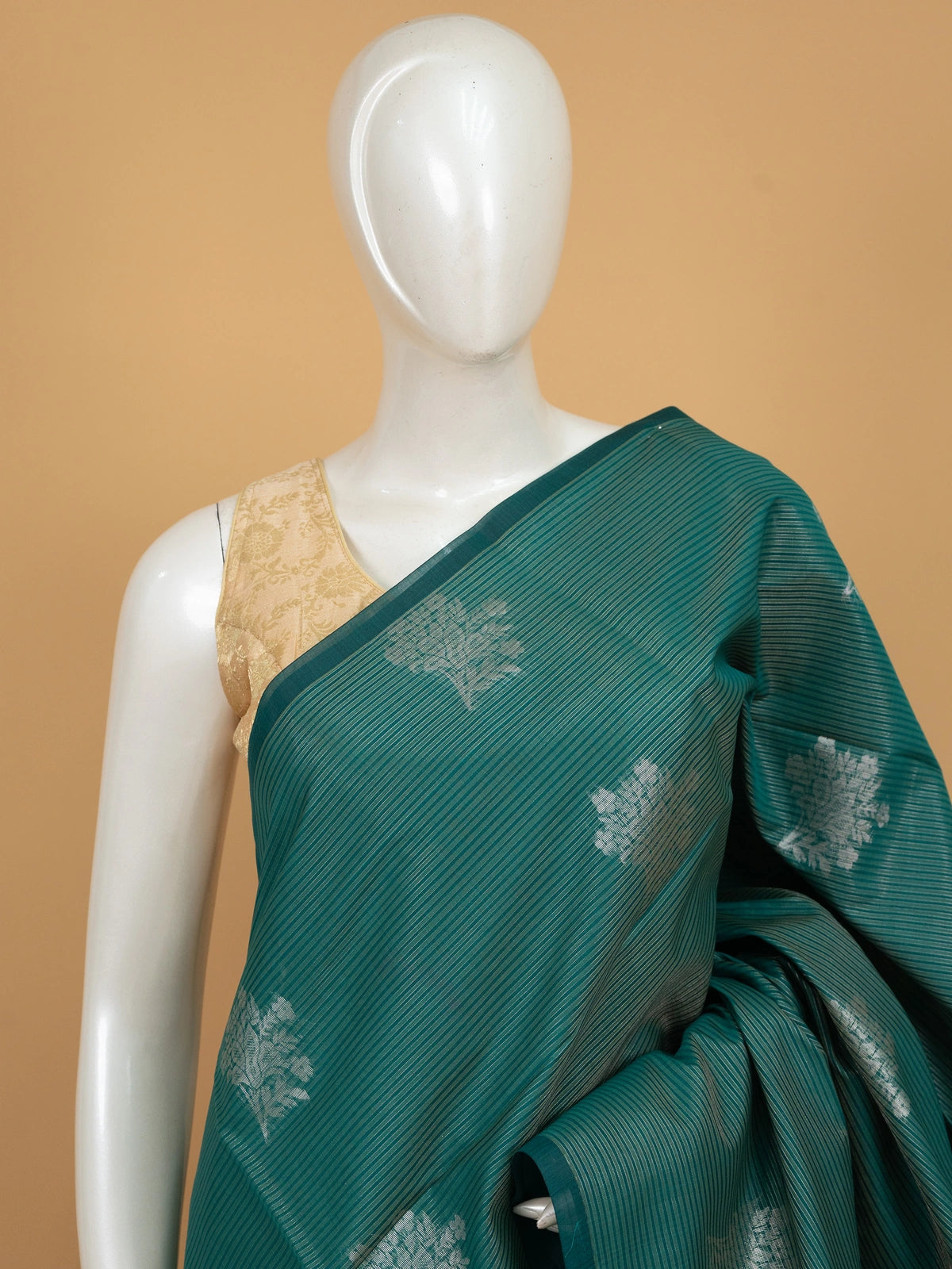 Teal green silk cotton saree with silver zari floral butta and ornate zari pallu