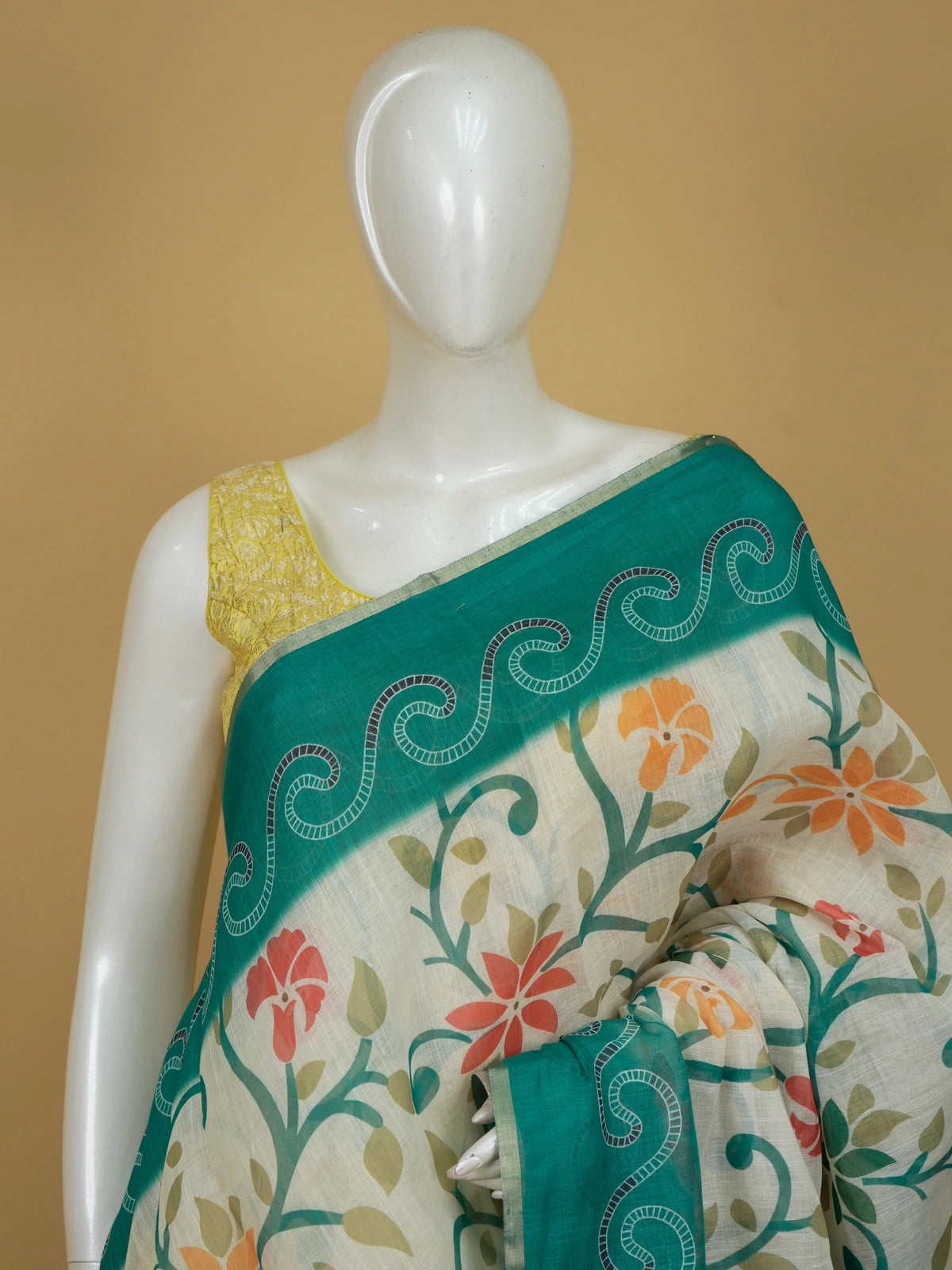 Cream linen cotton saree with multicolour floral print and contrast teal green paisley border