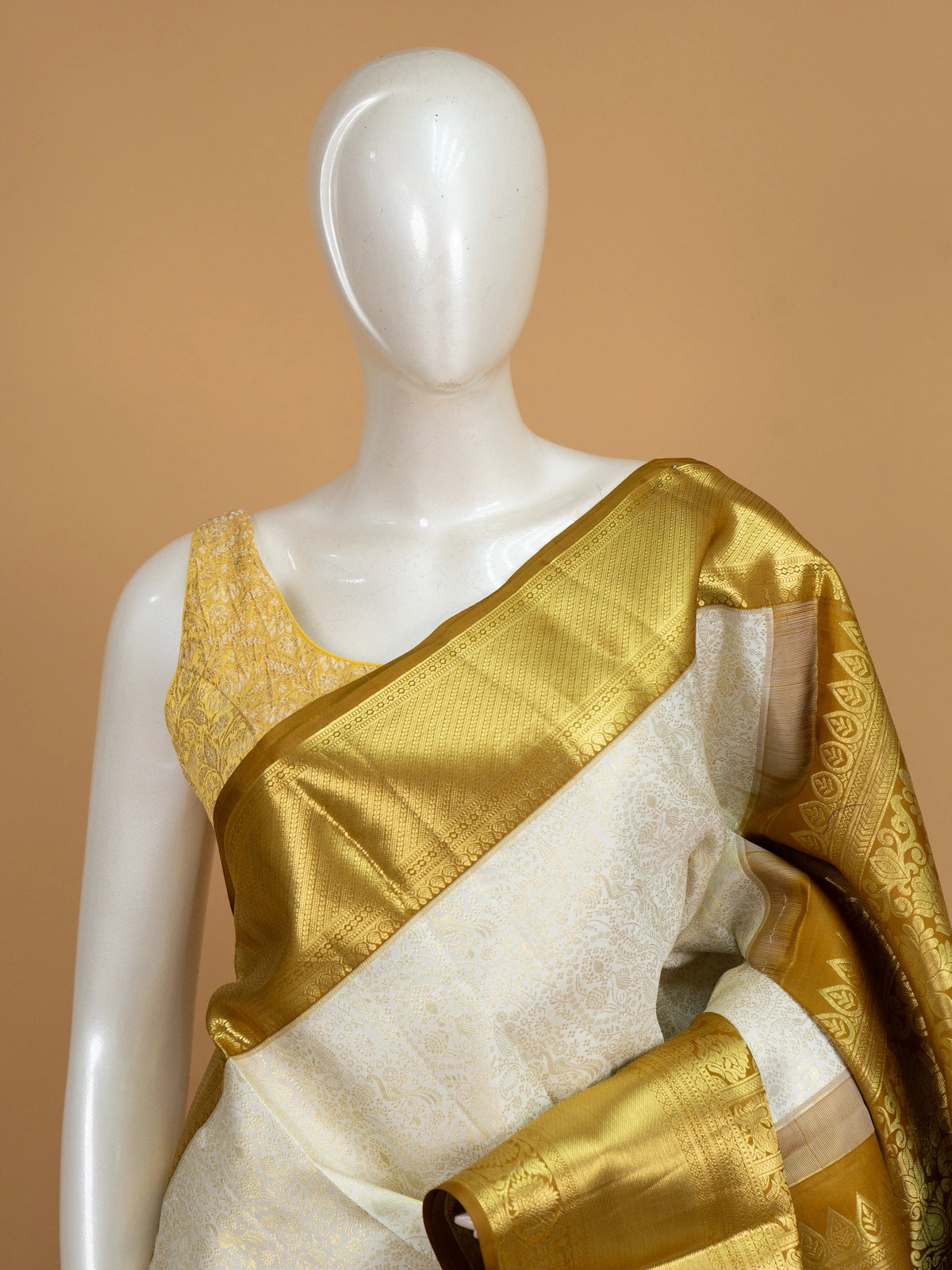 Cream pure Kanchipuram silk saree with gold zari floral and peacock border and pallu