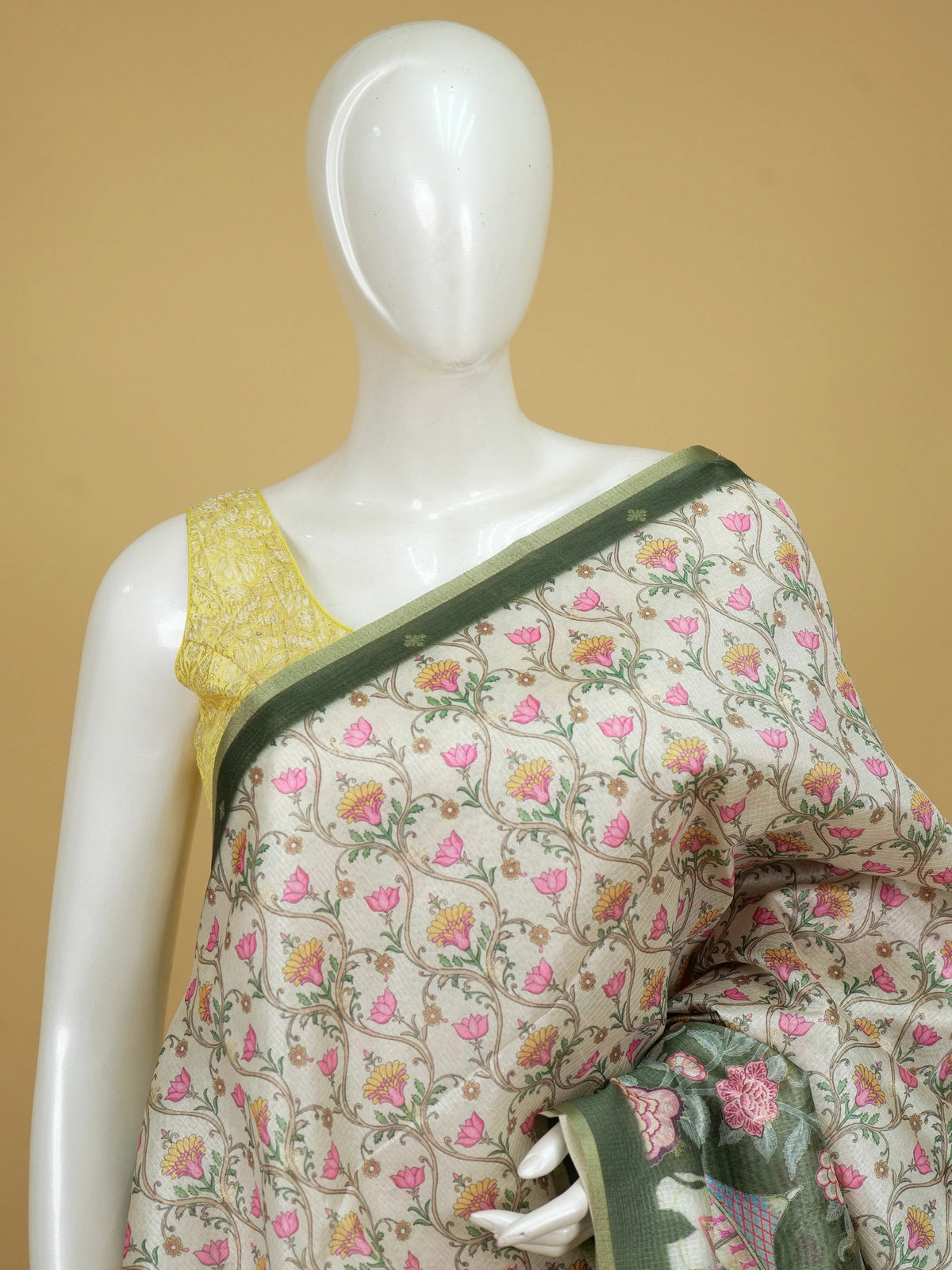 Cream semi tussar saree with floral jaal body, olive green elephant pallu and golden zari border