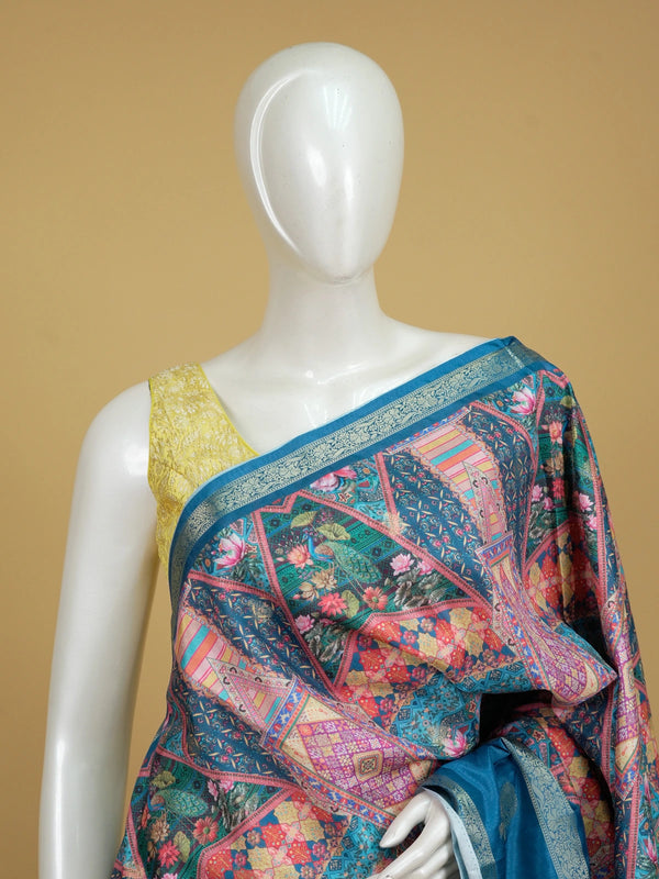 Teal blue and multicolour Dola silk saree with patchwork floral print and silver zari contrast border