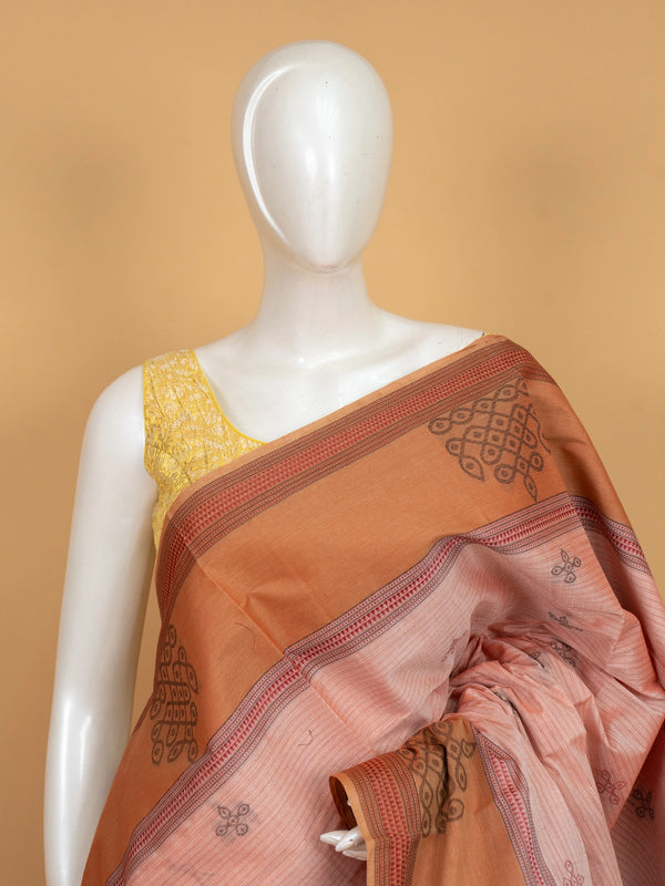 Pale pink and rust semi raw silk saree with kolam motifs and contrast patterned border