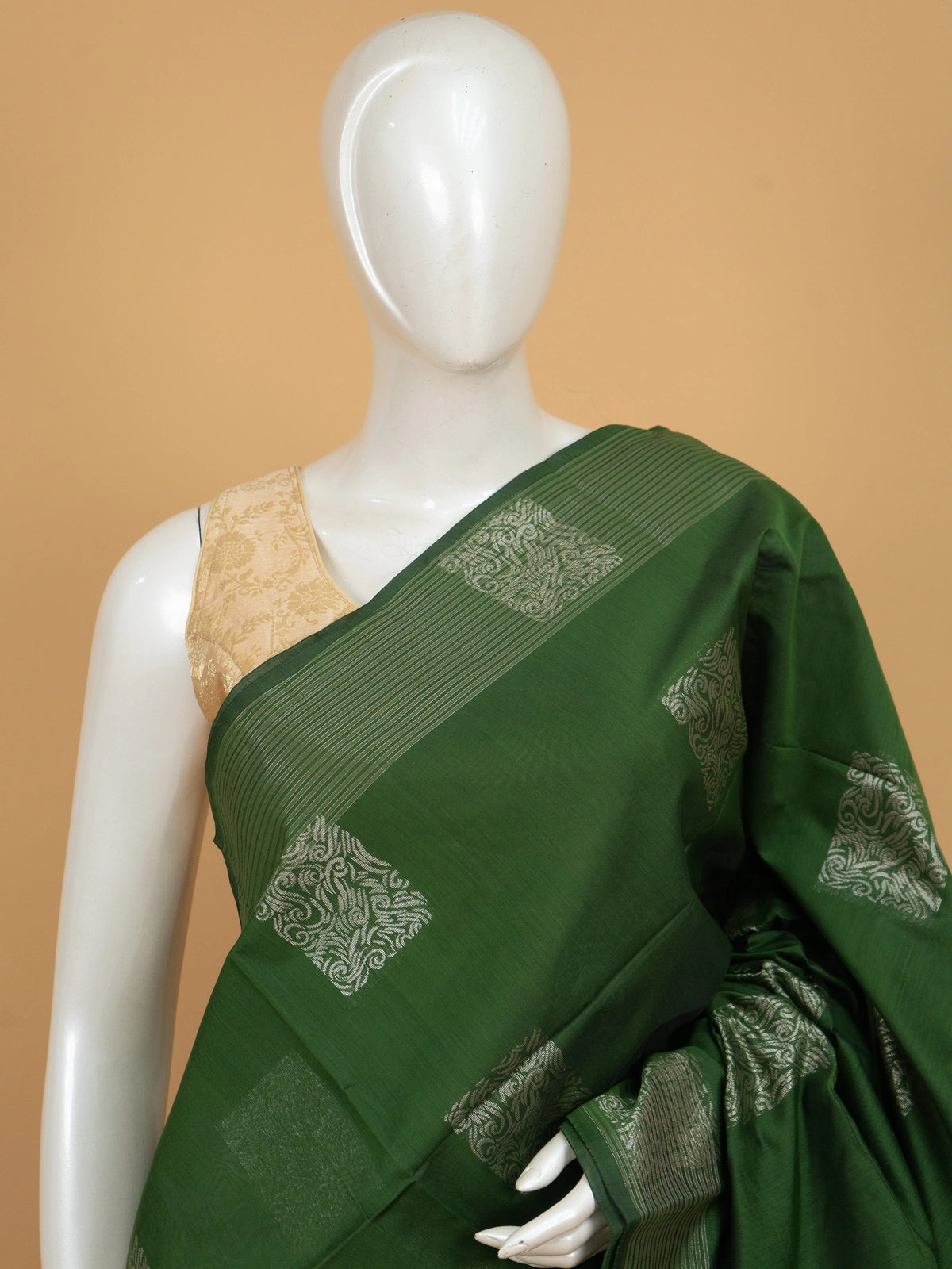 Green silk cotton saree with silver zari square buttas and temple-triangle border