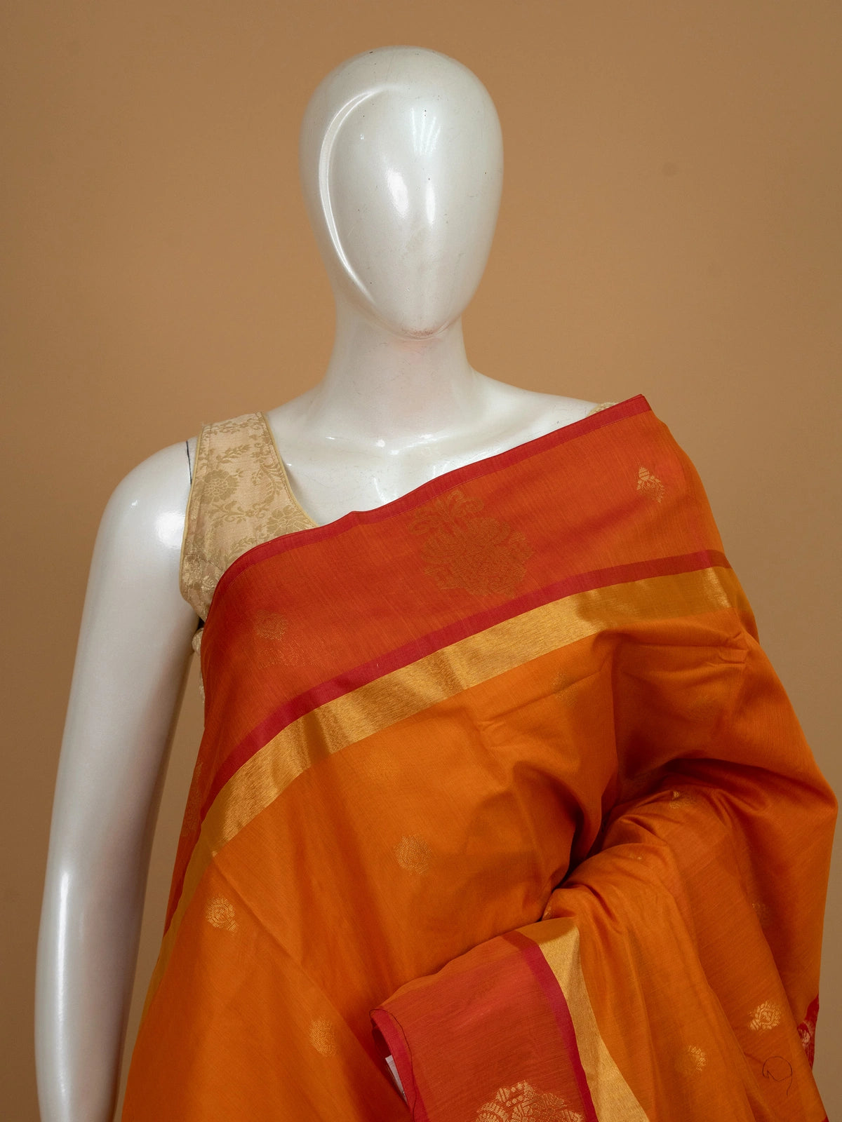 Orange silk cotton saree with contrast red gold zari pallu and border