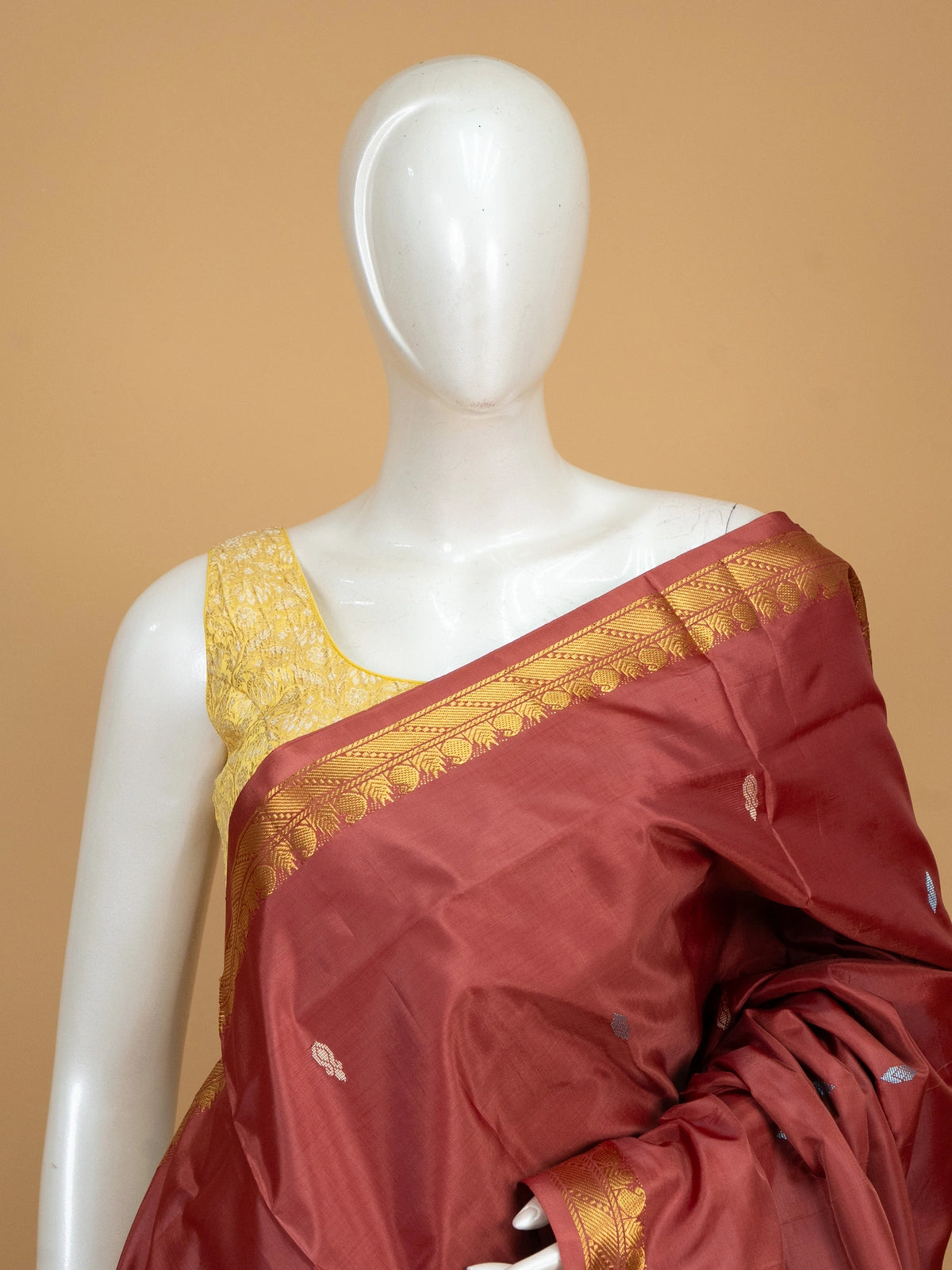 Maroon banana silk saree with gold zari border and contrast cream striped pallu