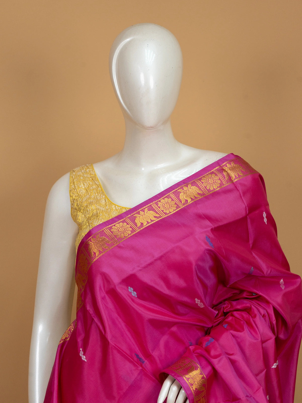 Pink banana silk saree with gold zari border, blue buti motifs and contrasting sky blue pallu