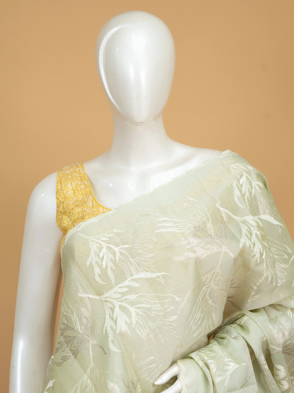 Sage green organza designer saree with white leaf embroidery and contrast yellow blouse