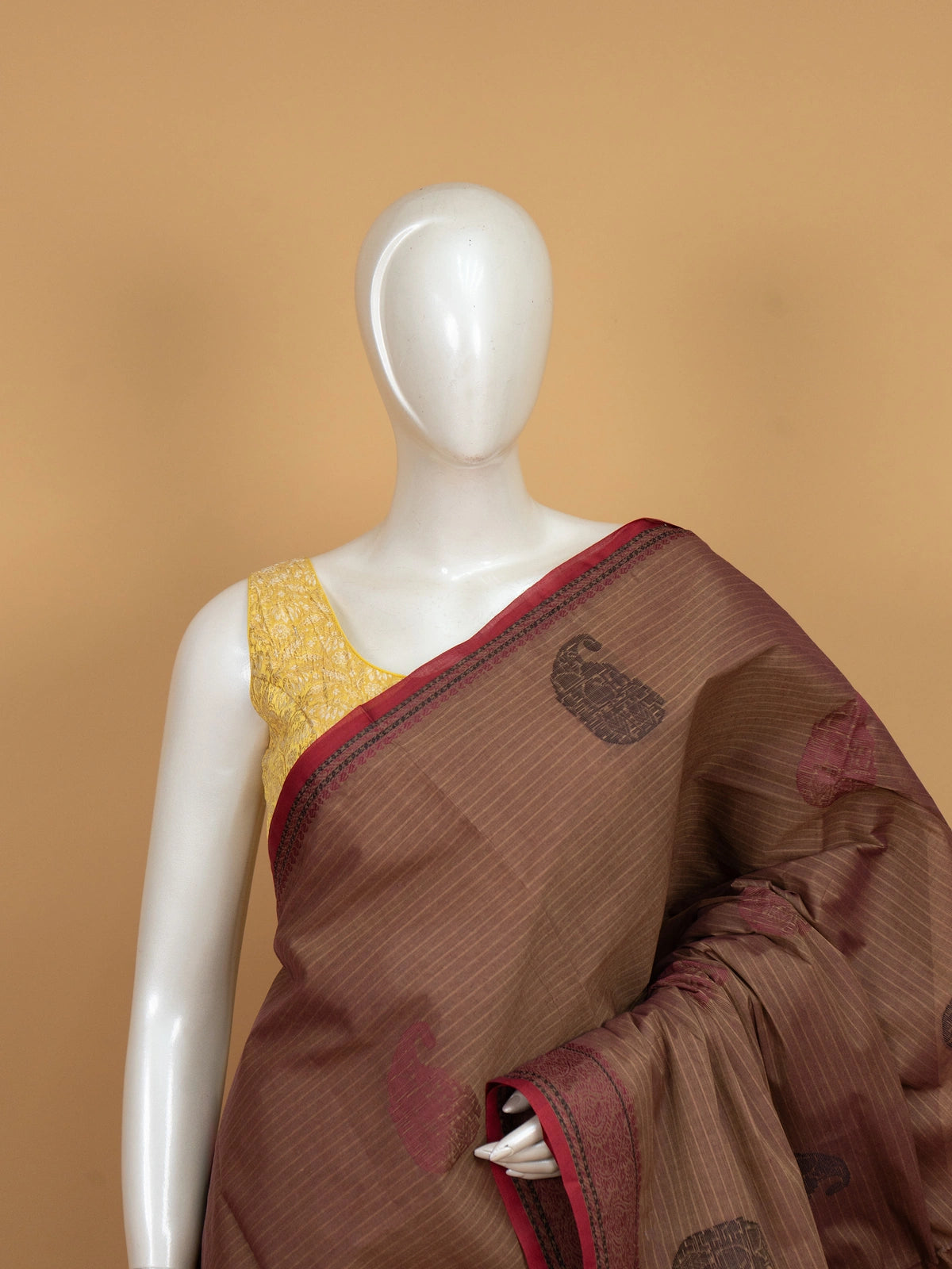 Brown and maroon semi raw silk saree with woven paisley motifs and contrast border