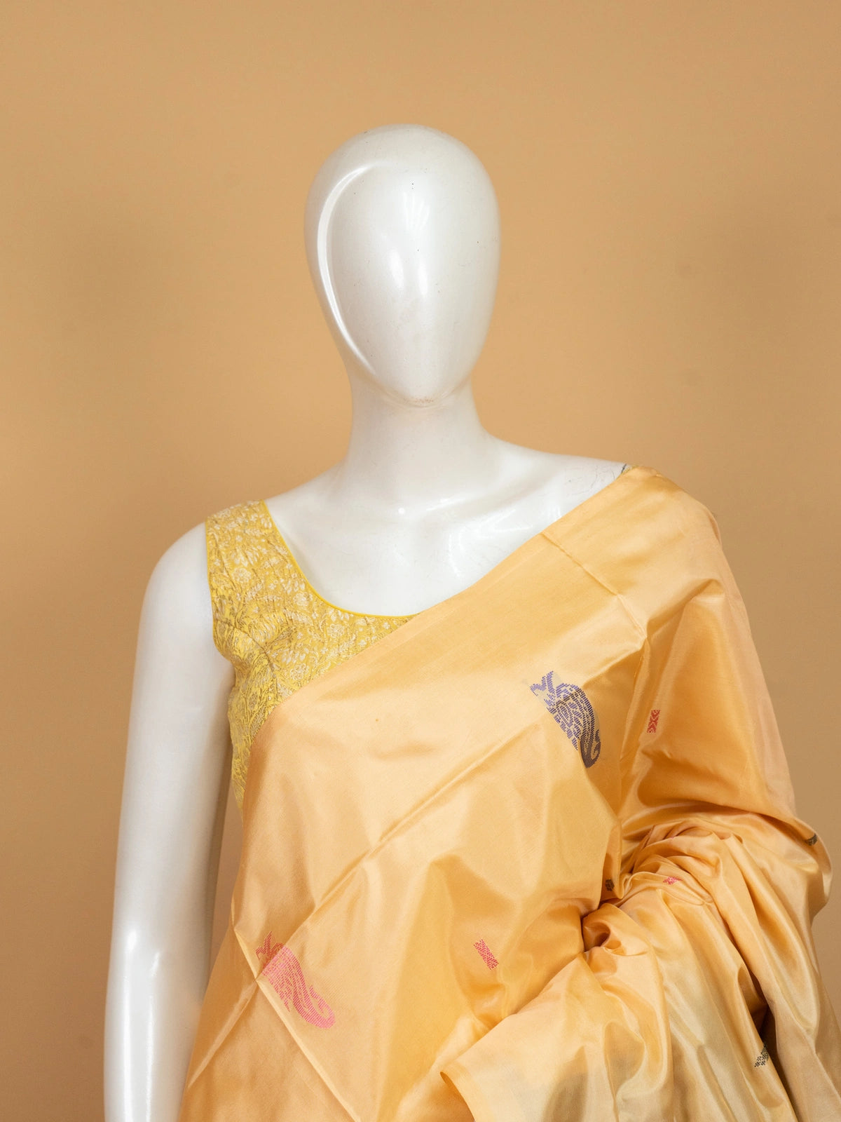 Golden yellow banana silk saree with plum contrast pallu, zari stripes and paisley buttas