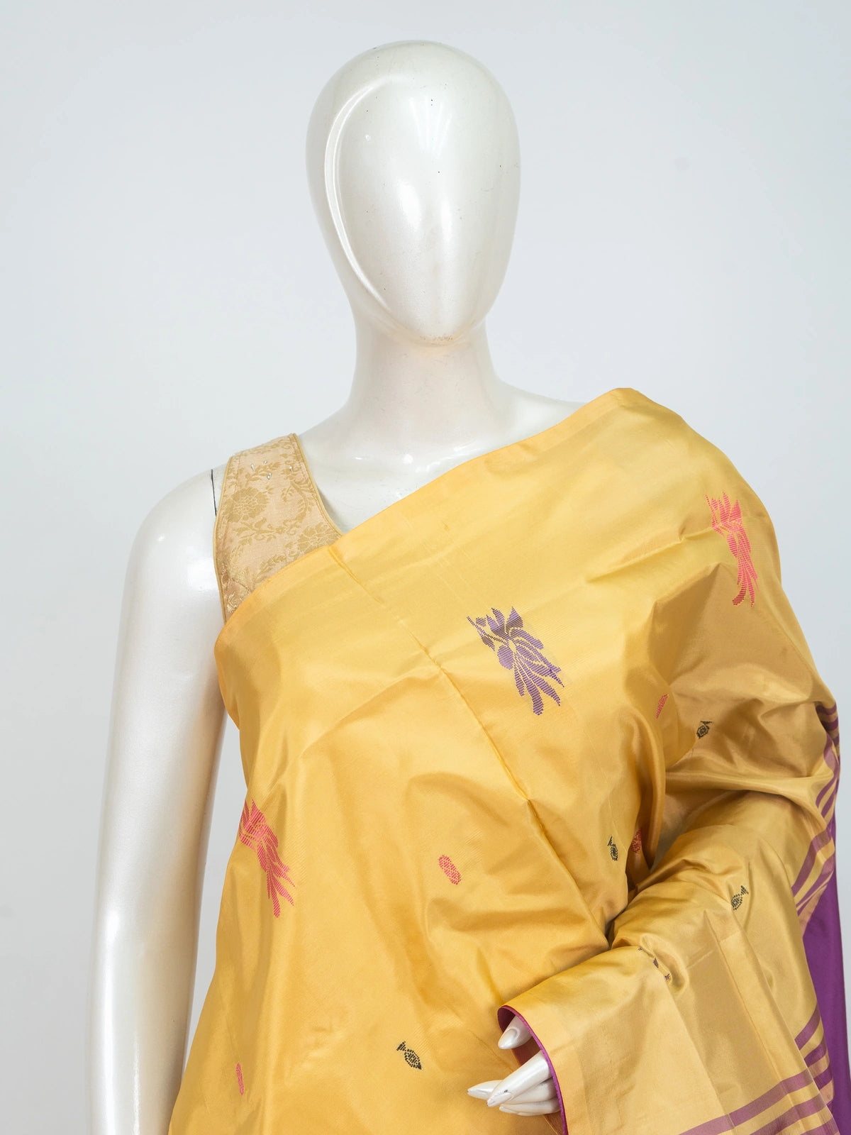 Mustard yellow banana silk saree with contrast magenta pallu, gold zari striped border and woven floral buttas