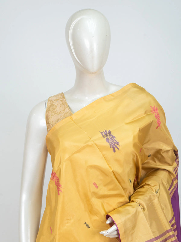 Mustard yellow banana silk saree with contrast magenta pallu, gold zari striped border and woven floral buttas