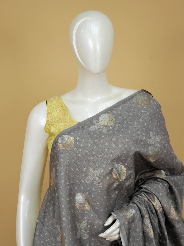 Grey designer saree with gold and silver woven floral buttas and a golden zari tissue border