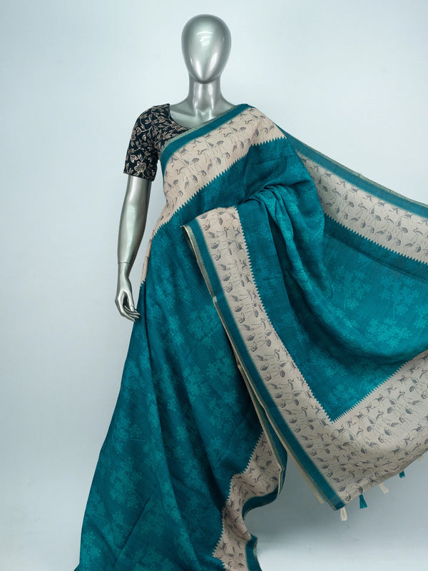 Teal linen cotton saree with cream crane-motif contrast border and temple-style edging