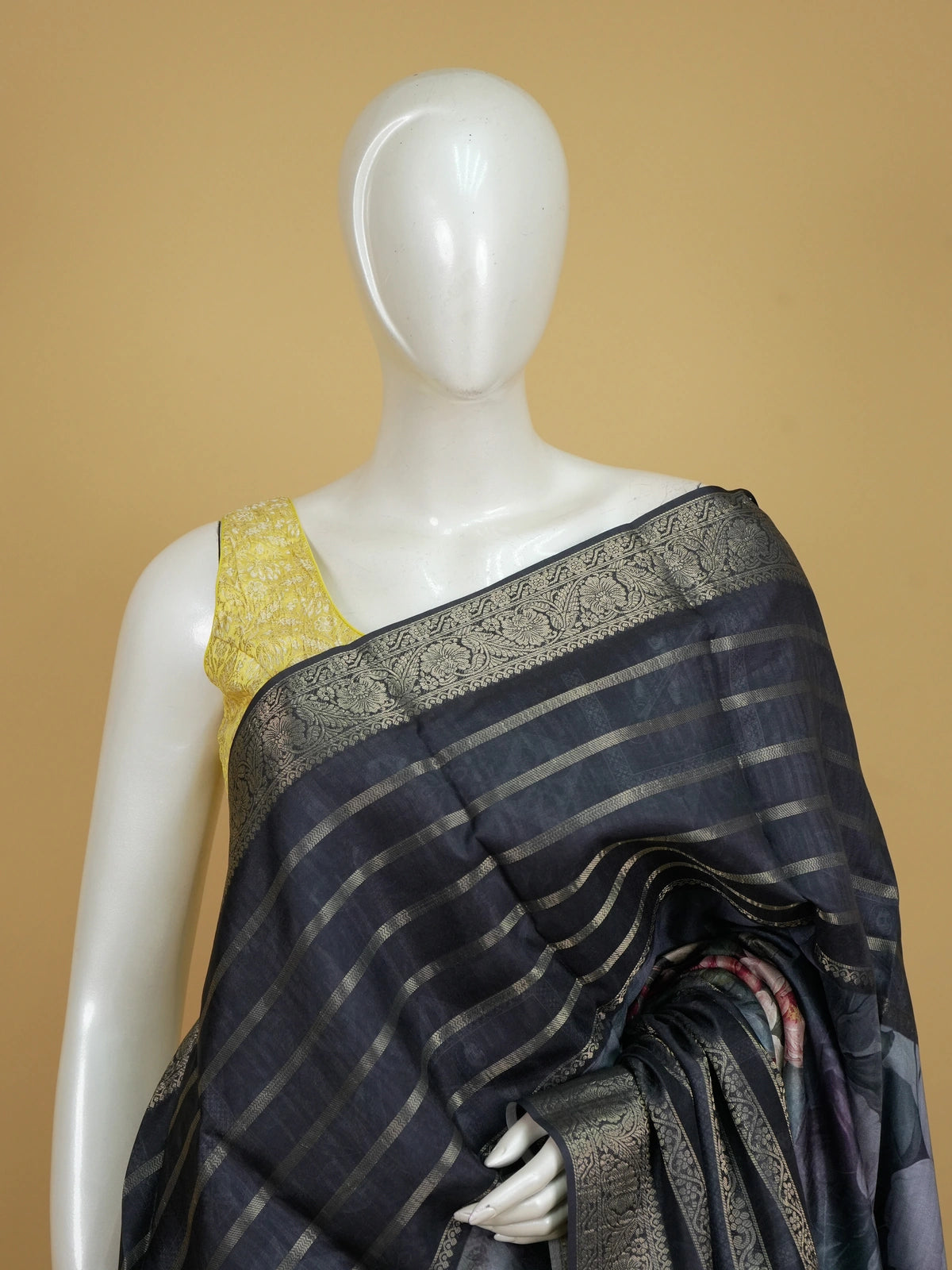 Charcoal grey semi tussar saree with gold zari stripes, floral prints, and a woven gold border