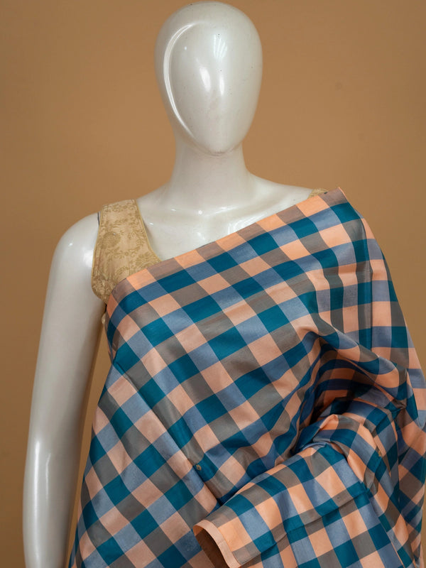 Teal blue and peach checked banana silk saree with contrast peach pallu and woven leaf motifs