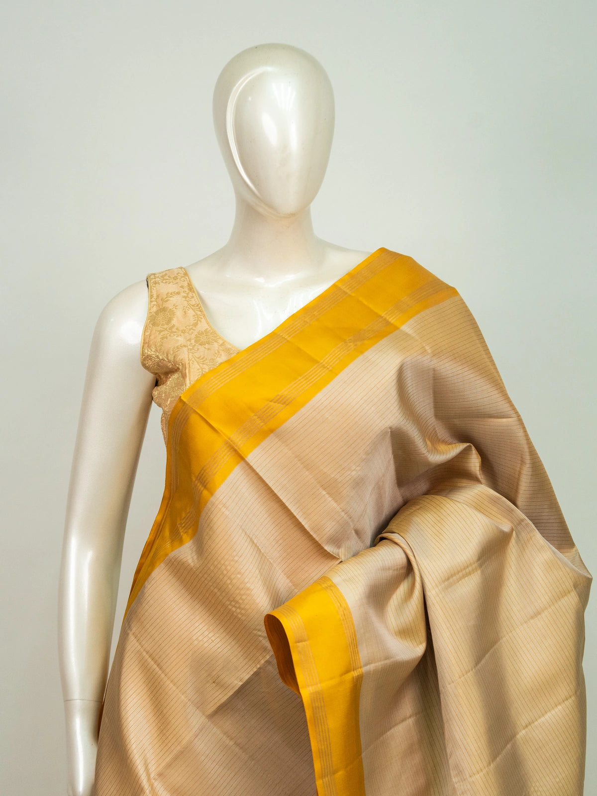 Cream pure soft silk saree with contrast mustard-yellow gold zari border and tasselled pallu