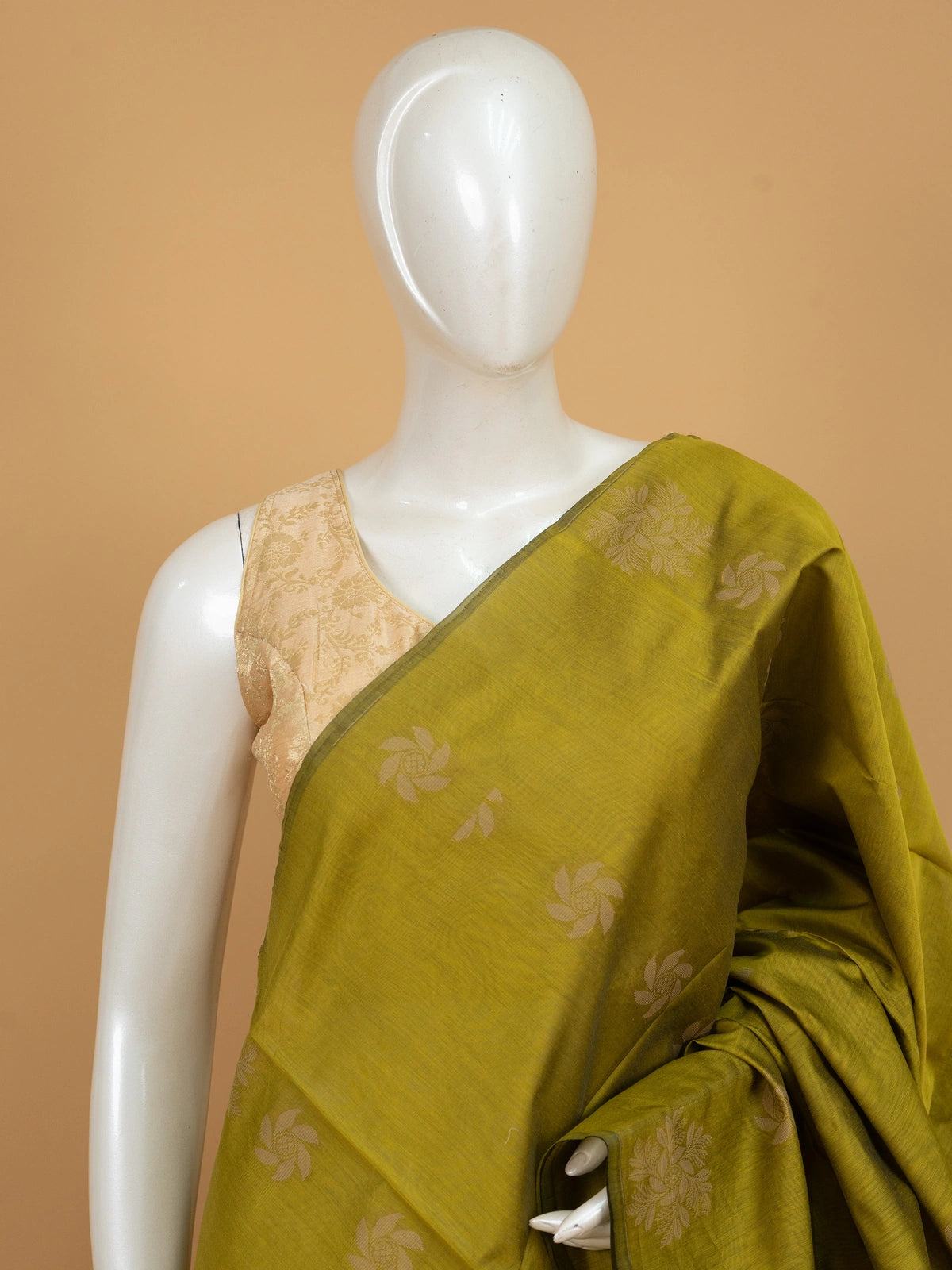 Olive green silk cotton saree with cream woven floral buttas and decorative border