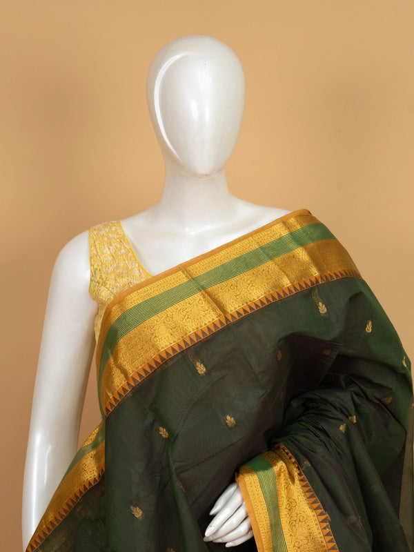 Dark green Chettinad cotton saree with mustard gold zari border and woven floral pallu