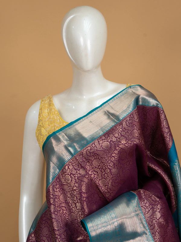 Purple pure Kanchipuram silk saree with silver zari floral weaving and contrast teal blue border and pallu