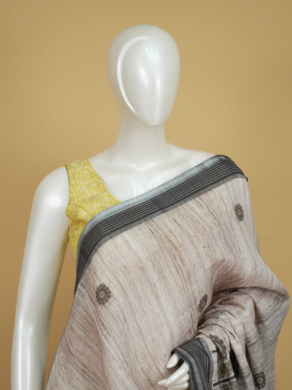 Beige linen cotton saree with grey floral prints and a contrast grey-black striped border