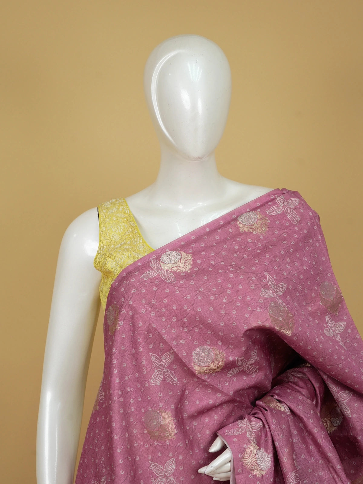 Rose pink designer saree with bandhani-effect texture, gold zari floral buttas and a zari tissue border