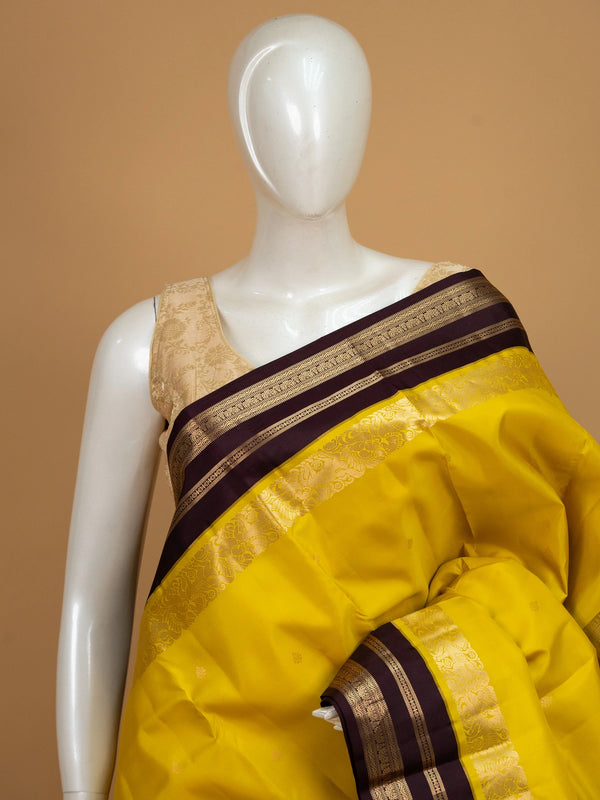 Yellow pure Kanchipuram silk saree with contrast wine border and gold zari brocade pallu