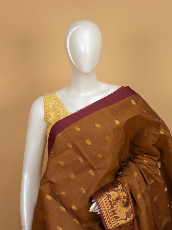 Mustard brown Chettinad cotton saree with maroon contrast border, gold zari buttas and woven pallu