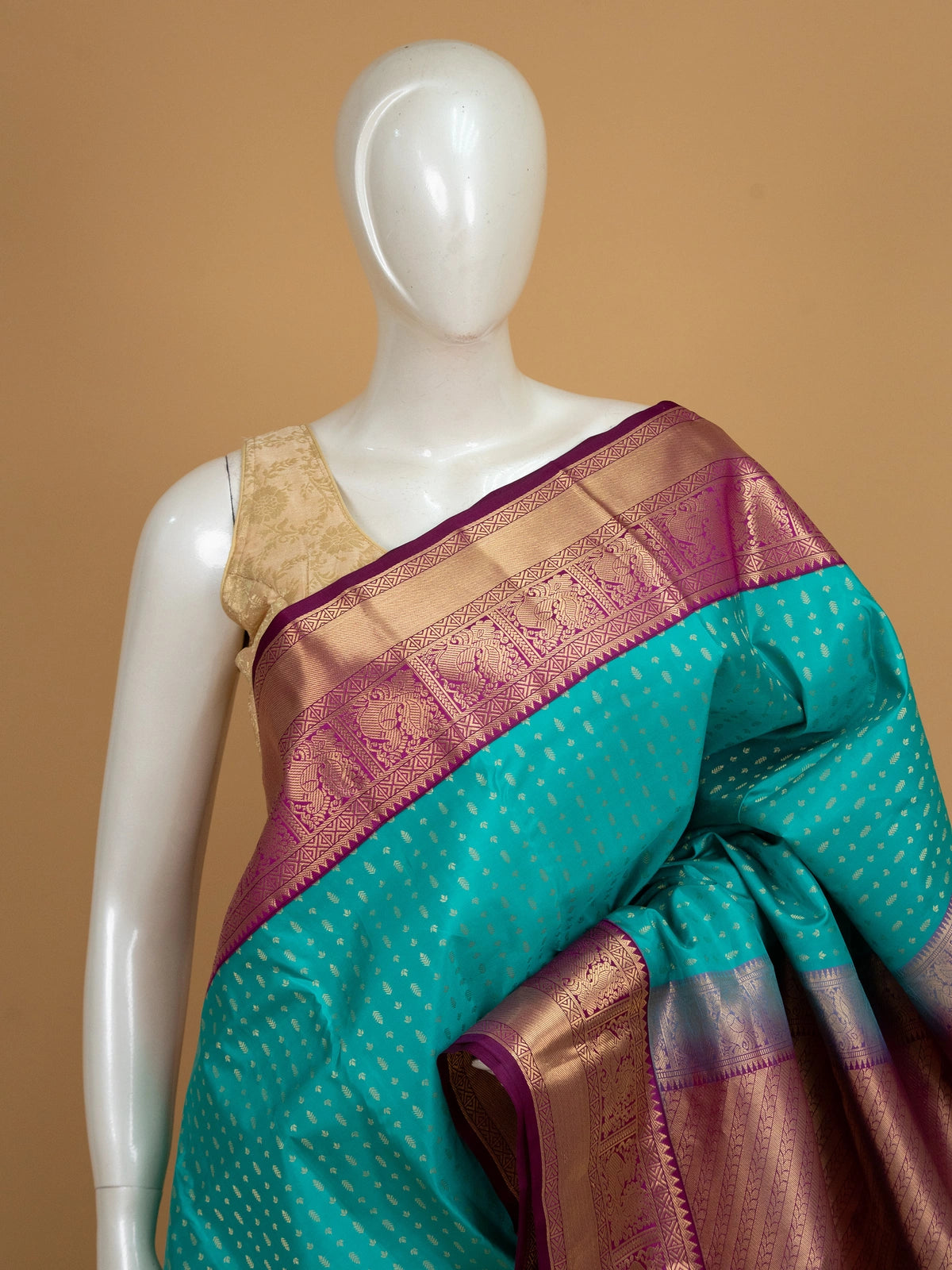 Teal pure Kanchipuram silk saree with gold zari butis and contrast magenta zari border and pallu