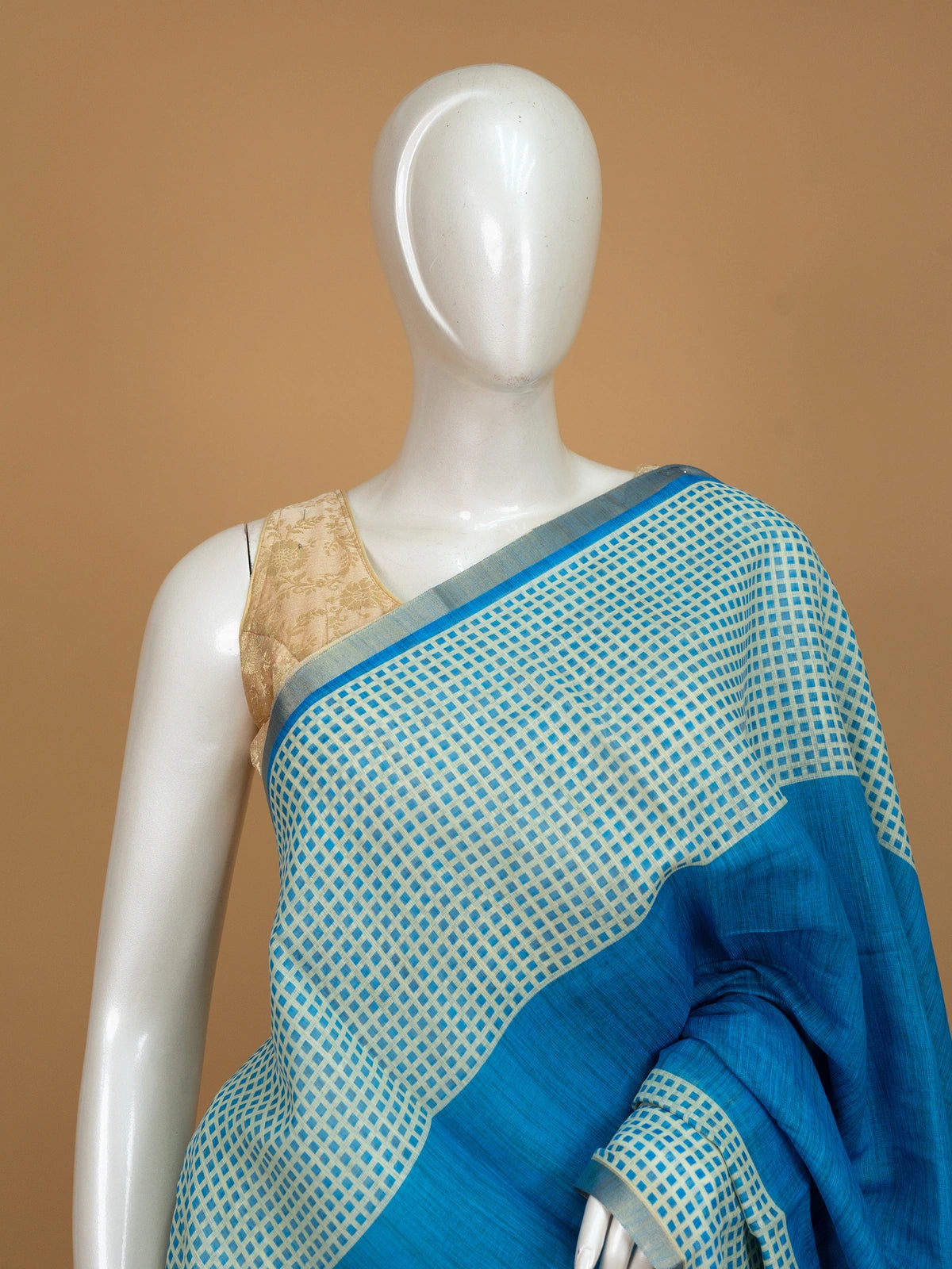 Peacock blue linen cotton saree with cream checked body, silver zari border and printed pallu