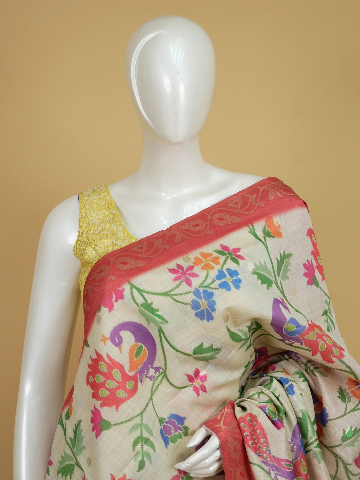 Cream linen cotton saree with multicolour peacock floral weave and red zari border